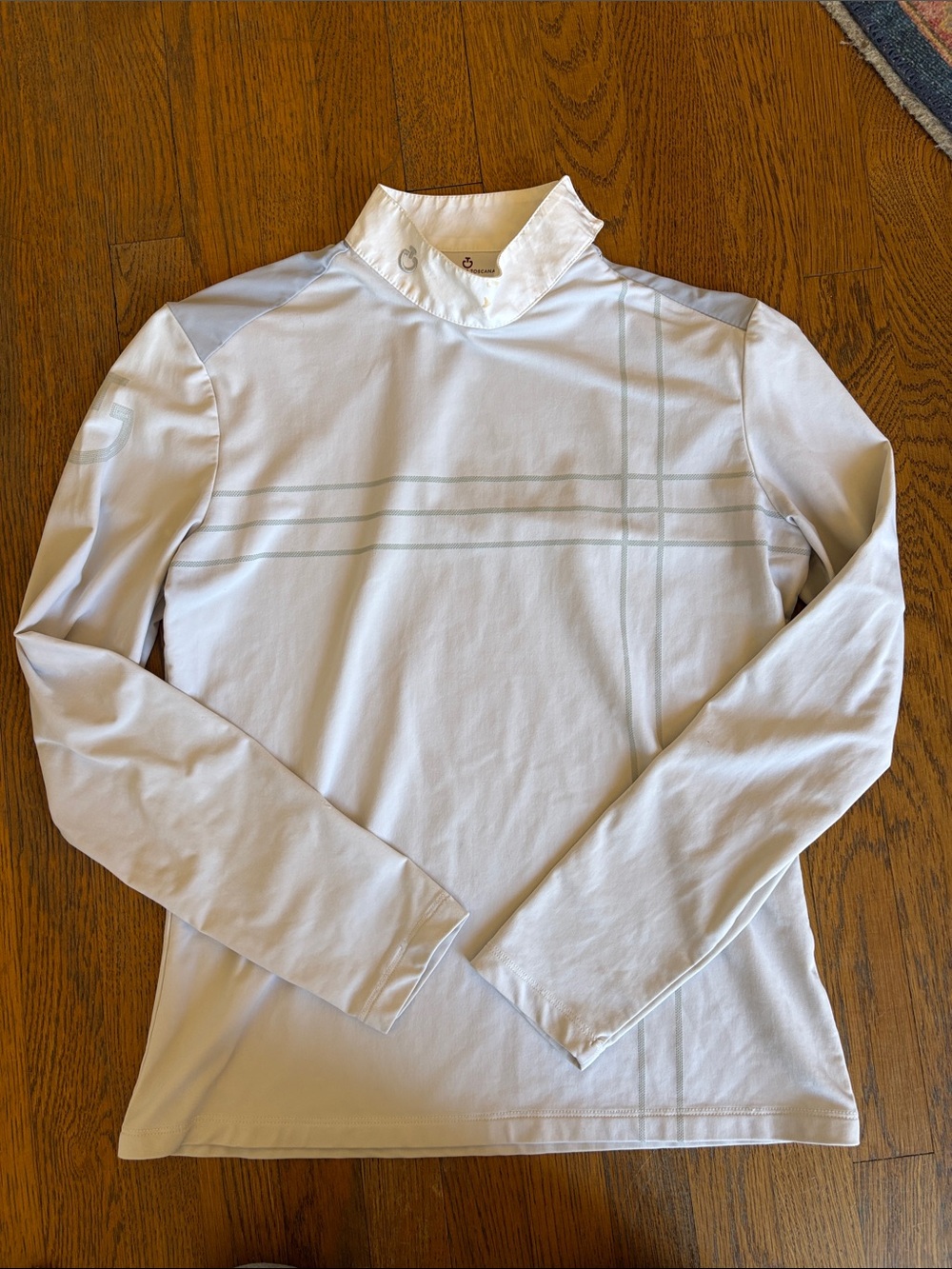 Women’s White Long-Sleeve Performance Tee with Subtle Stripe and arm brand